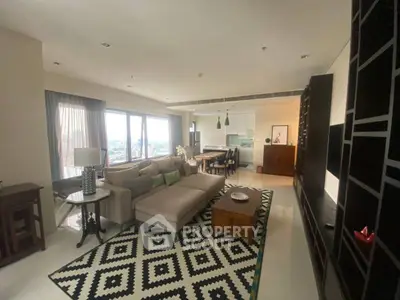 Spacious living room with modern decor and open kitchen layout