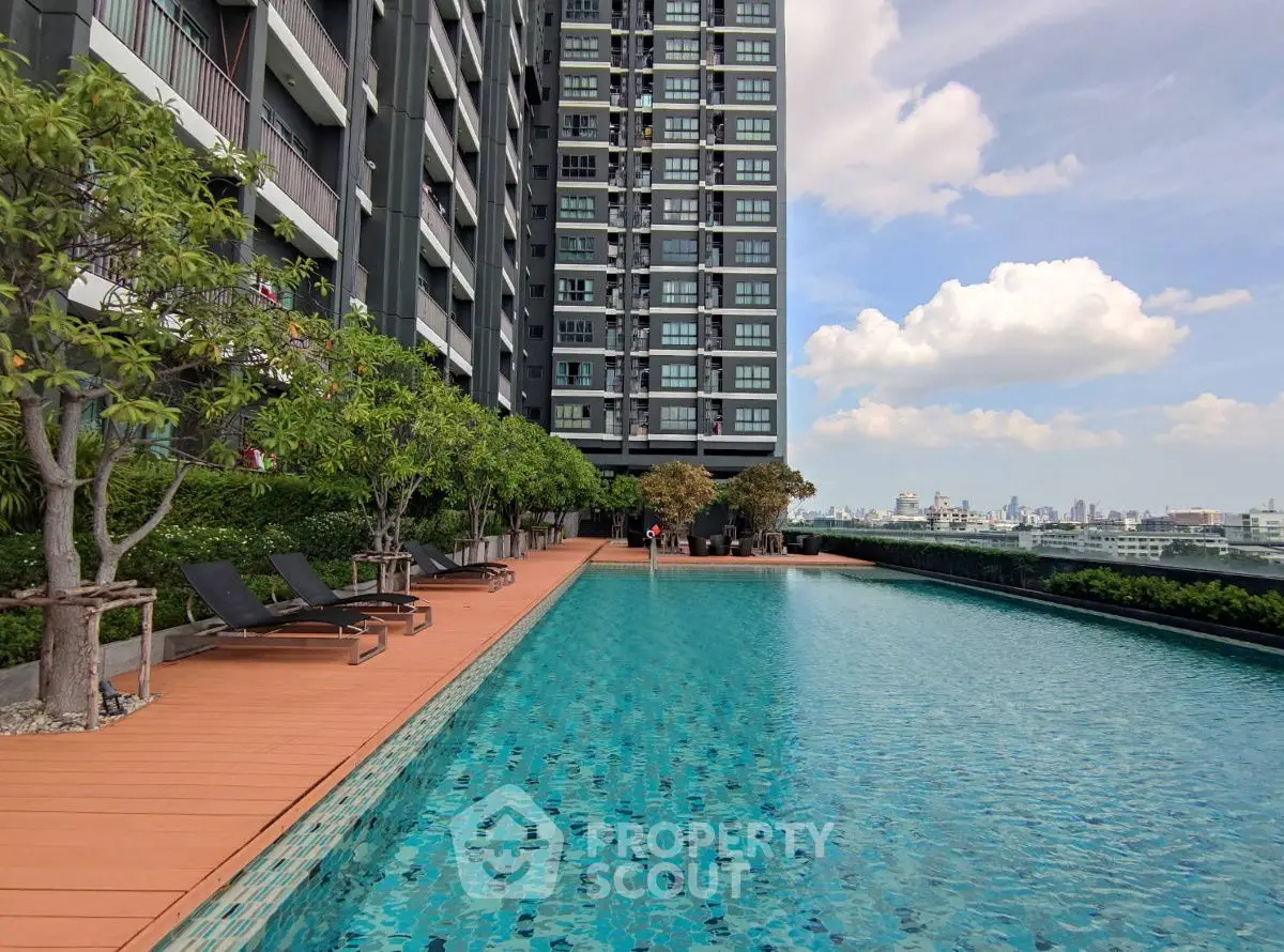 Luxurious rooftop pool with stunning city view in modern high-rise building.