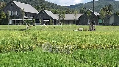 Stunning countryside estate with lush green fields and mountain backdrop