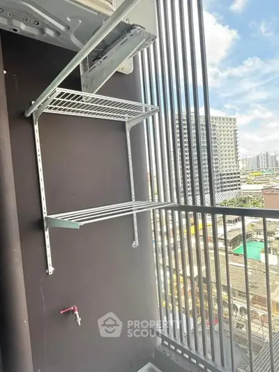 Modern balcony with drying rack and city view, perfect for urban living.