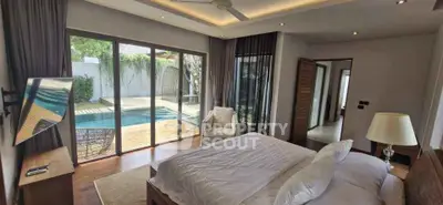 Luxurious bedroom with pool view and modern decor in a stunning property