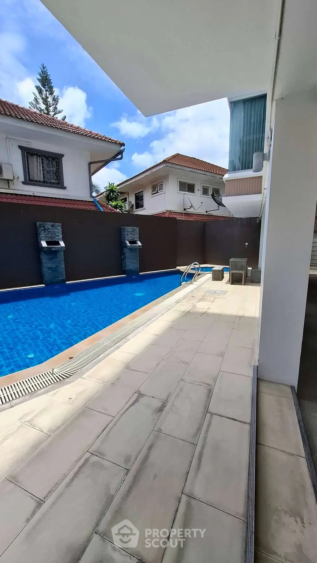 Luxurious outdoor pool area with modern design and spacious deck, perfect for relaxation and entertainment.