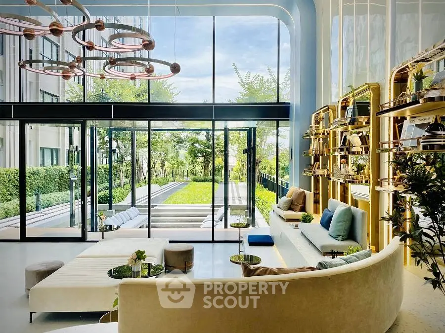 Luxurious modern living room with floor-to-ceiling windows and garden view, featuring elegant decor and ample natural light.