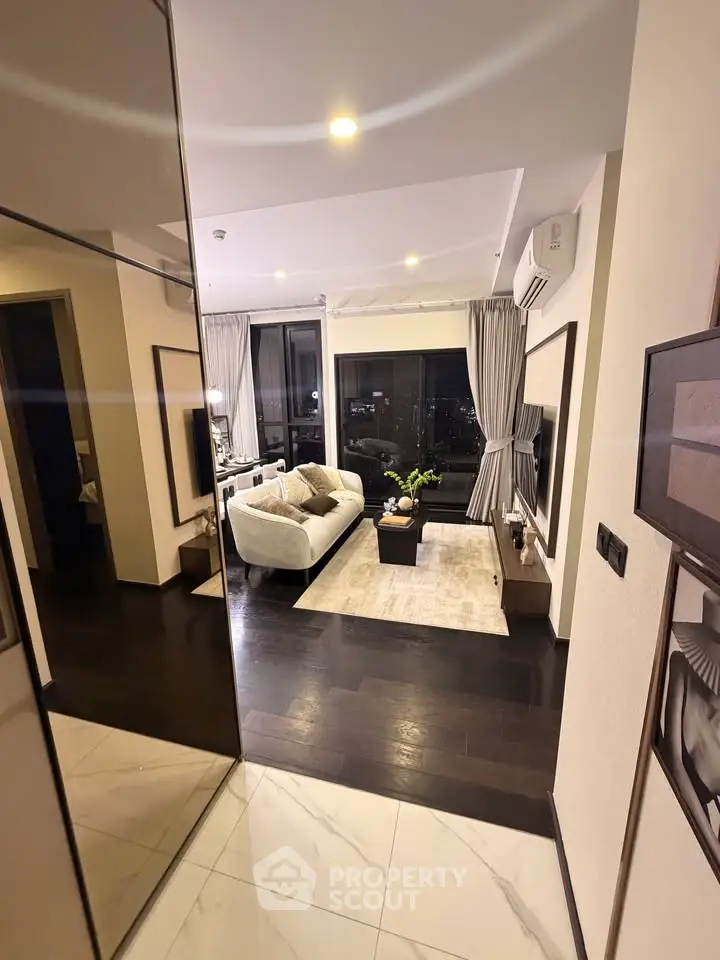Modern living room with elegant decor and city view, featuring cozy seating and stylish lighting.