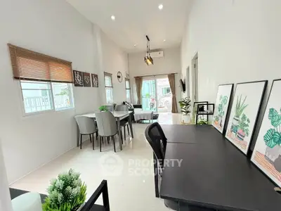 Modern open-plan living and dining area with stylish decor and ample natural light.