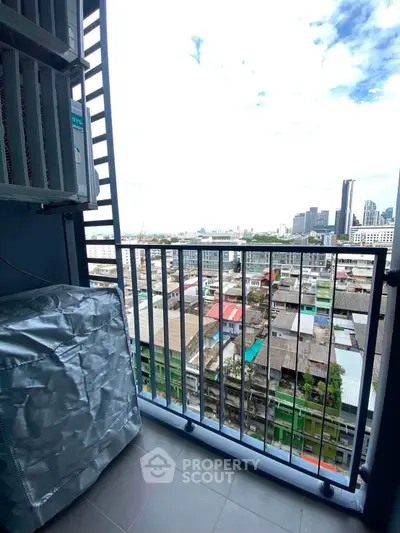 Urban balcony with cityscape view, ideal for enjoying skyline vistas and fresh air in a modern apartment setting.