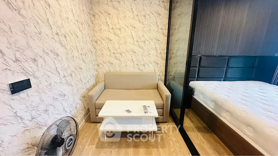 Modern bedroom with stylish decor and cozy seating area