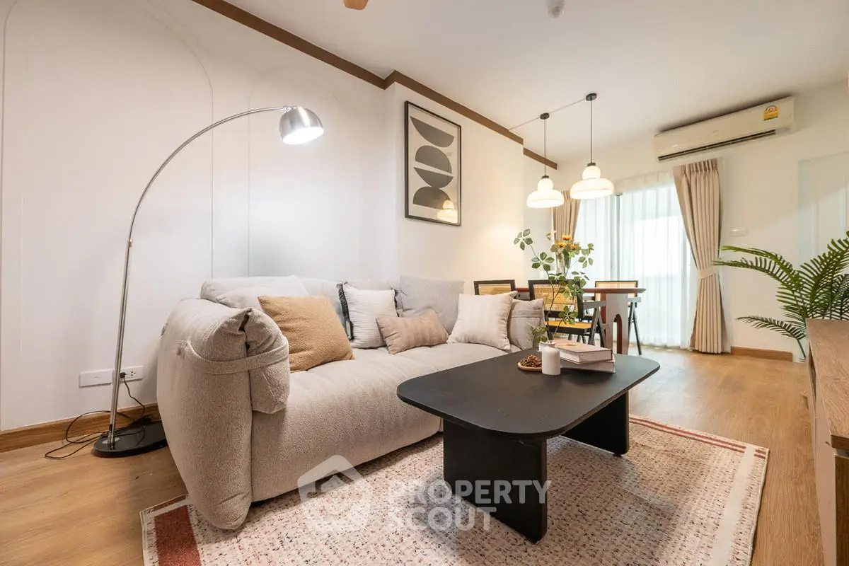 Modern living room with cozy sofa, stylish decor, and warm lighting in a contemporary apartment.
