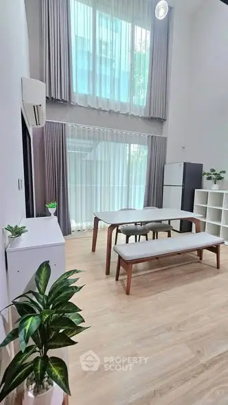 Spacious modern living room with high ceilings and elegant decor