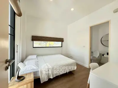 Modern bedroom with ensuite bathroom and natural light