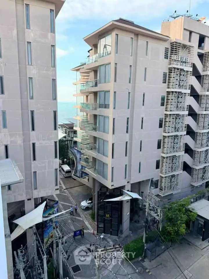Modern high-rise building with ocean view and urban surroundings