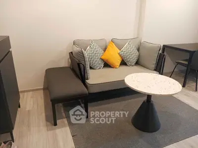 Modern living room with stylish sofa, accent pillows, and chic coffee table in cozy apartment.