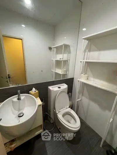 Compact bathroom with modern fixtures and open shelving