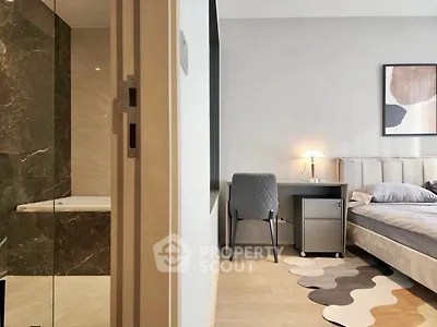Modern bedroom with ensuite bathroom featuring elegant decor and stylish furniture.