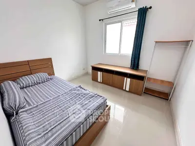 Spacious bedroom with modern furniture and natural light