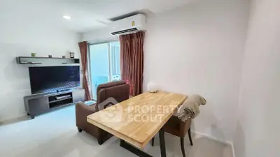 Modern living room with wooden table, TV, and air conditioning