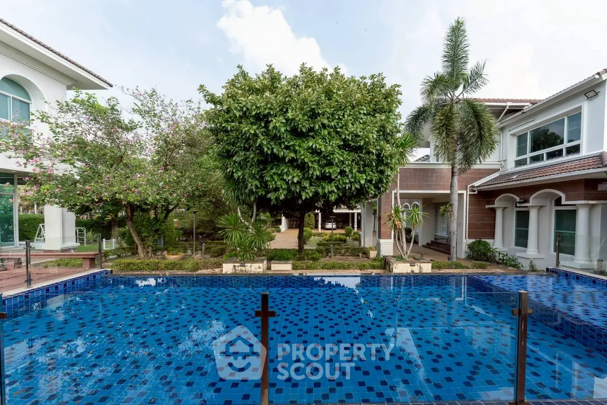 Luxurious villa with a stunning pool and lush garden, perfect for relaxation and entertainment.