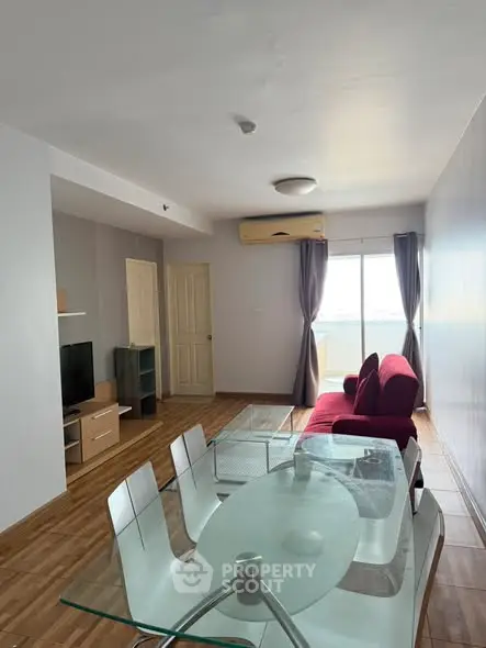 Spacious living room with modern furniture and balcony view