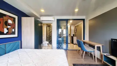 Modern bedroom with stylish decor and ensuite bathroom in a contemporary apartment.