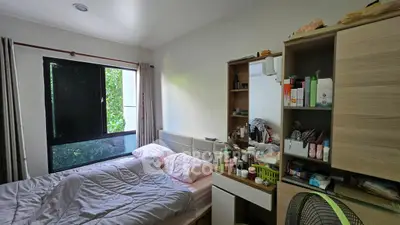 Cozy bedroom with natural light and organized storage space.
