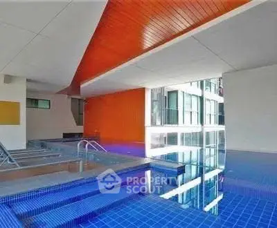 Luxurious indoor pool with modern architecture and vibrant design in a high-end residential building.