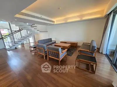 Spacious modern living room with wooden flooring and stylish furniture