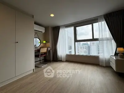 Spacious modern bedroom with city view and stylish decor