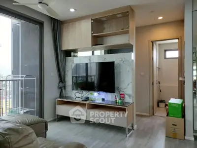 Modern living room with sleek TV unit and balcony view, perfect for urban living.
