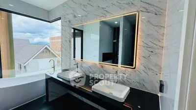 Luxurious bathroom with dual sinks and large mirror in modern home with scenic view.