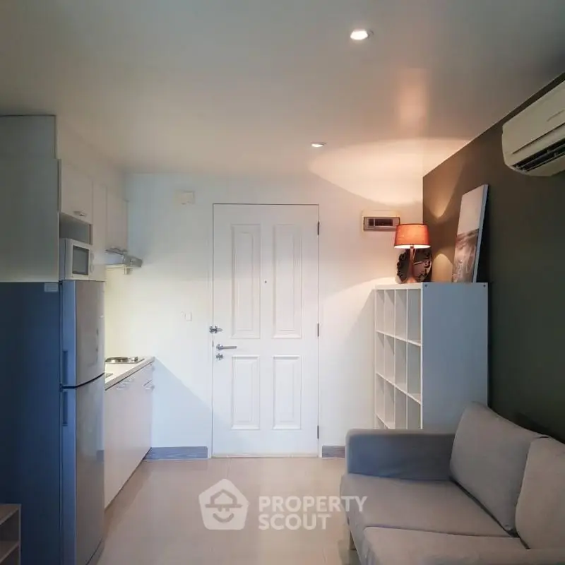 Modern compact living room with kitchenette and stylish decor