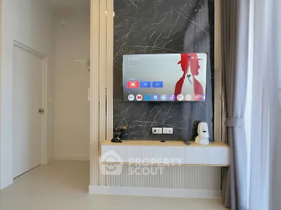 Modern living room with wall-mounted TV and stylish decor