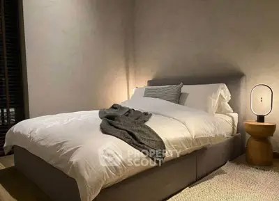 Cozy bedroom with modern decor and ambient lighting, perfect for relaxation.