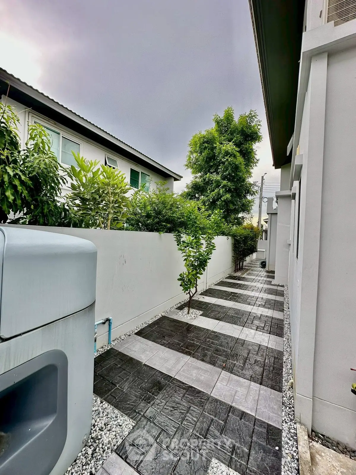 Modern exterior pathway with sleek design and lush greenery