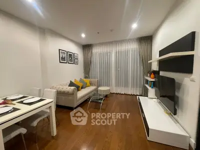 Modern living room with elegant decor, featuring a cozy sofa, dining area, and entertainment unit.