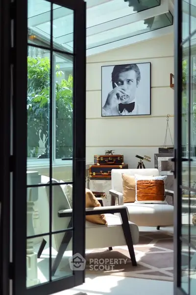 Luxurious sunlit living room with elegant decor and glass ceiling
