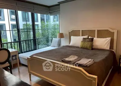 Elegant bedroom with large windows and stylish decor in modern apartment