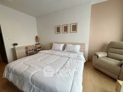 Spacious bedroom with modern decor and comfortable furnishings in a stylish apartment.