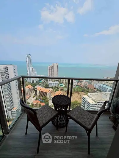Stunning balcony view overlooking cityscape and ocean, perfect for relaxation.