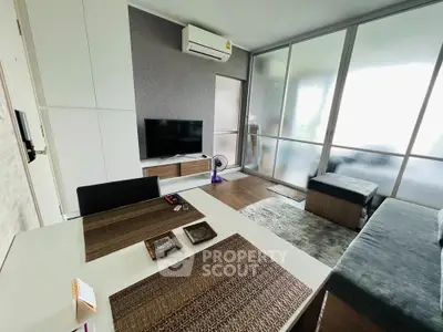 Modern living room with sleek furniture and large windows in a stylish apartment.