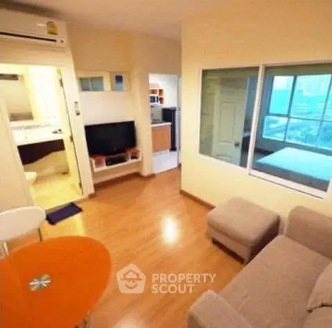 Cozy living room with modern furniture and open layout in a city apartment.