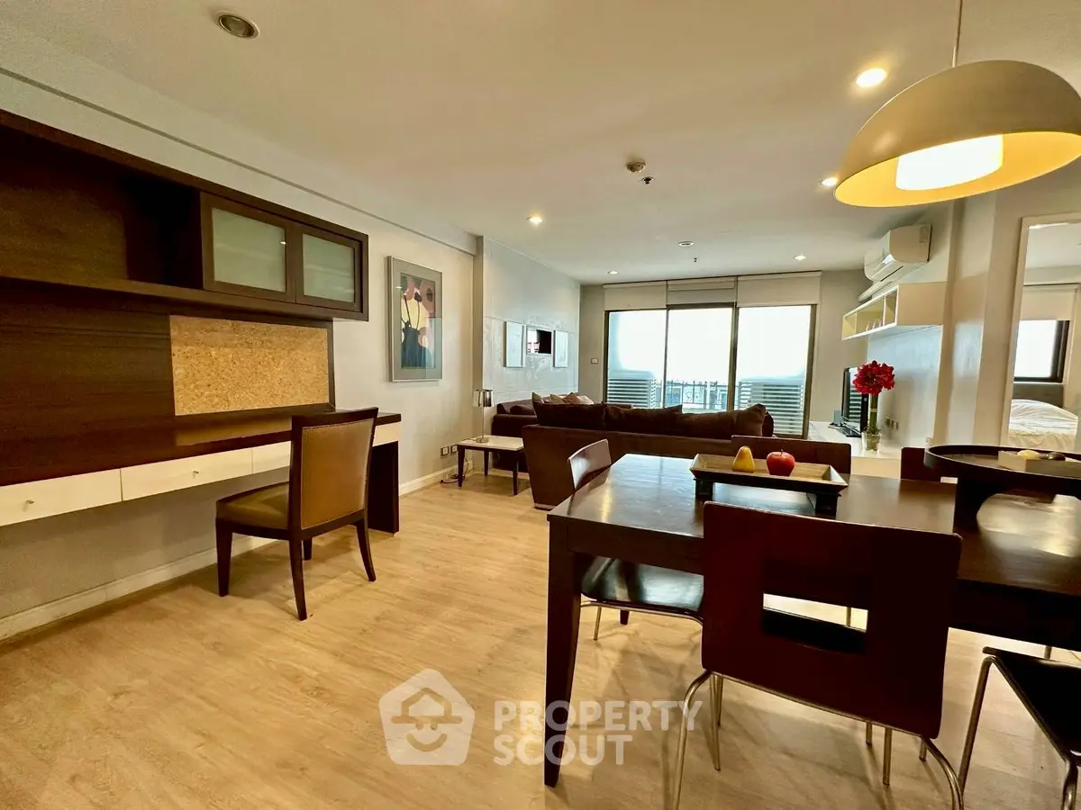 Spacious open-plan living and dining area with modern furnishings and natural light.