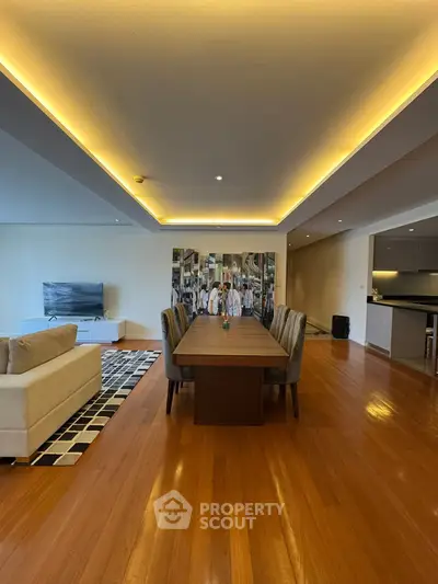 Spacious modern living room with elegant dining area and open kitchen layout.