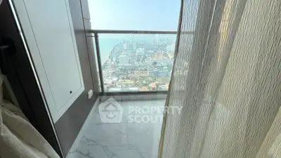 Stunning high-rise balcony with panoramic city and sea view, perfect for urban living.