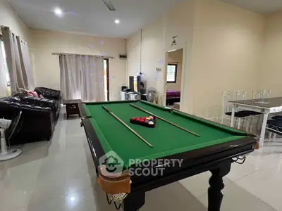 Spacious living room with pool table and modern furnishings