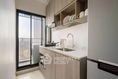 Modern kitchen with sleek cabinetry and balcony view, featuring a compact design and stylish appliances.