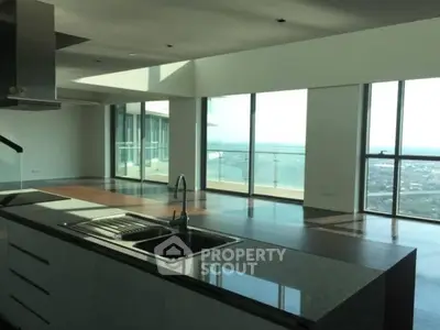 Luxurious open-plan kitchen with stunning city view and spacious living area