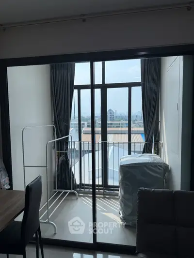 Modern apartment with balcony offering city views and ample natural light.