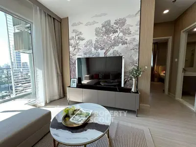 Modern living room with stylish decor and city view, featuring elegant furniture and natural light.