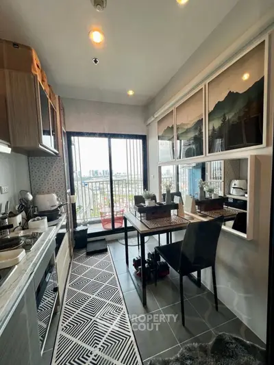 Modern kitchen with open layout and city view from balcony