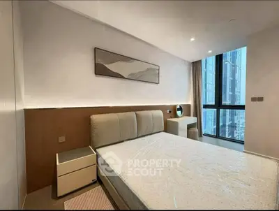 Modern bedroom with large window and stylish decor in urban apartment